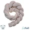 A braided baby nest on a white background with logos in the corners. Náhled obrázku produktu