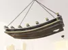 A wooden wine rack shaped like a boat, suspended from the ceiling by chains. Produktbild-Vorschau