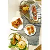 A collection of appetizers and snacks arranged on a table. Podgląd zdjęcia produktu