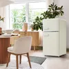 A retro-style cream refrigerator is shown in a dining area with a table and chairs. Produktbild-Vorschau