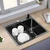 A kitchen sink with dishes drying in a rack. Produktbild-Vorschau