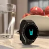 A smartwatch is placed on a countertop next to a glass of water and a bowl of apples. Anteprima dell’immagine prodotto