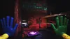 A first-person perspective of a dark, industrial-looking room with red lighting. The user's hands, one blue and one green, are visible in the foreground, along with a glowing purple hand icon on a tablet. Náhled obrázku produktu