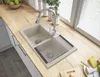 A kitchen sink area with a roll-up drying rack over the sink, a faucet, and a wooden countertop. Podgląd zdjęcia produktu