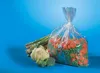 A bag of frozen vegetables and some fresh vegetables on a blue background. Podgląd zdjęcia produktu