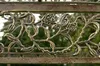 A close-up of ornate metalwork with rose and leaf motifs, likely part of a garden structure. Anteprima dell’immagine prodotto