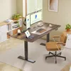 A modern home office setup with a standing desk, ergonomic chair, and dual monitors. Produktbild-Vorschau