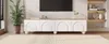A modern living room with a TV stand and a large plant. Voir les images du produit