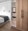 A bedroom with a bed and a closet. Produktbild-Vorschau