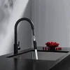 A black kitchen faucet with a pull-down sprayer is shown over a stainless steel sink. A bowl of cherries is on the countertop. Anteprima dell’immagine prodotto