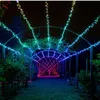 A garden path illuminated by colorful string lights at night. Náhled obrázku produktu