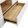 A close-up view of an open drawer in a white and wood-grain sideboard. Voir les images du produit