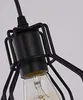 Close-up of a vintage-style pendant light fixture with a black metal cage and a clear Edison-style bulb. Produktbild-Vorschau