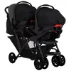 A tandem stroller with two car seats attached, shown from a side-angle. Voir les images du produit