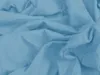 A close-up view of crumpled light blue fabric. Náhled obrázku produktu