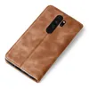 A brown leather flip case for a smartphone is shown against a white background. Produktbild-Vorschau