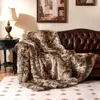 A plush faux fur blanket draped over a leather sofa in a living room setting. Náhled obrázku produktu