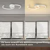 A split image showing a modern ceiling lamp in two different lighting conditions, with a view of blinds and windows below. Produktbild-Vorschau