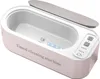 A top-down angled view of a white and pink ultrasonic jewelry cleaner. Produktbild-Vorschau