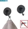 Two black wall hooks are shown against a white background. One hook is holding a folded towel. A graphic indicating no drilling is required is in the bottom right corner. Produktbild-Vorschau