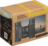 The image shows the packaging of National Geographic binoculars, with a scenic background and a person hiking. Produktbild-Vorschau