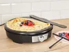 A crepe maker with a finished crepe on top, with berries and sauce. Produktbild-Vorschau