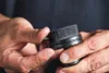 Hands holding a black applicator brush with bristles. Anteprima dell’immagine prodotto