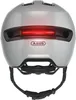 Rear view of a gray bicycle helmet with a red LED light strip. Produktbild-Vorschau