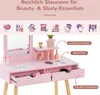 A pink vanity desk with a mirror, drawers, and decorative elements, overlaid with text and icons indicating storage and beauty essentials. Podgląd zdjęcia produktu