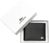 A black leather wallet is presented in its white Lacoste branded box. Voir les images du produit