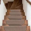A set of brown stair treads on wooden stairs. Voir les images du produit