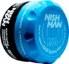 A close-up, angled shot of a blue and black hair styling wax container against a white background. Náhľad obrázku produktu