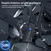 A black wireless USB adapter with two antennas, set against a dark, fragmented background that resembles shattered glass or debris. Produktbild-Vorschau