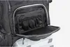 A close-up view of the open front pocket of a black fishing backpack, revealing internal organizers and storage compartments. Produktbild-Vorschau