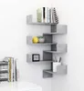 A corner shelf unit with books and decor items. Anteprima dell’immagine prodotto