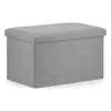 A gray fabric storage ottoman is shown against a white background. Podgląd zdjęcia produktu