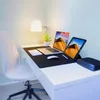 A clean and modern home office setup with a laptop, tablet, and desk accessories. Produktbild-Vorschau