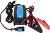 A battery charger with its cables and connectors. Anteprima dell’immagine prodotto