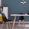 A dining room or office setting with two black chairs and a white table. Voir les images du produit