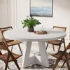 A round dining table with chairs in a dining room setting. Náhľad obrázku produktu