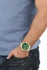 A person's arm and torso are shown, with the hand in the pocket of their jeans. A watch is visible on the wrist. Produktbild-Vorschau