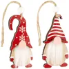 Two wooden gnome ornaments with red and white hats and white beards, hanging from twine. Náhled obrázku produktu