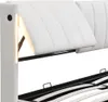 A close-up view of a white upholstered bed frame, showing the adjustable headboard and integrated LED lighting. Produktbild-Vorschau