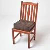 A brown seat cushion on a wooden chair against a white background. Náhled obrázku produktu