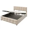 A beige upholstered bed frame with the mattress support mechanism lifted to reveal the storage compartment underneath. Produktbild-Vorschau