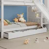 A child's bunk bed with a slide and storage, decorated with stuffed animals and toys. Produktbild-Vorschau