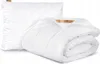 A white pillow and a folded white comforter are displayed on a white background. Podgląd zdjęcia produktu