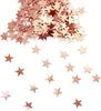 A pile of rose gold star-shaped confetti scattered on a white background. Produktbild-Vorschau