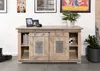 A wooden sideboard with sliding doors, decorated with framed pictures and plants on top, in a room setting. Voir les images du produit