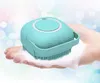 A teal silicone pet wash sponge with bristles is held in a hand covered in soap suds. Náhled obrázku produktu
